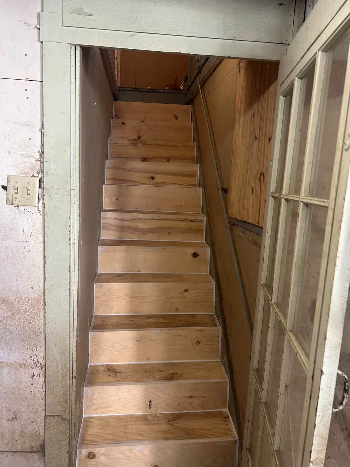The same staircase rebuilt with new wood treads and risers