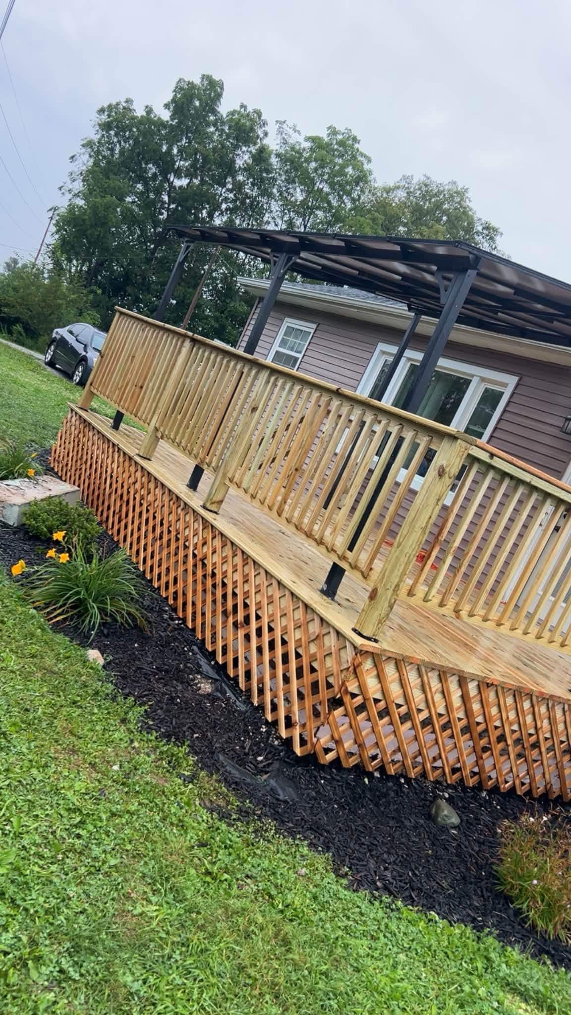 Finished wood deck with lattice skirting and covered patio structure